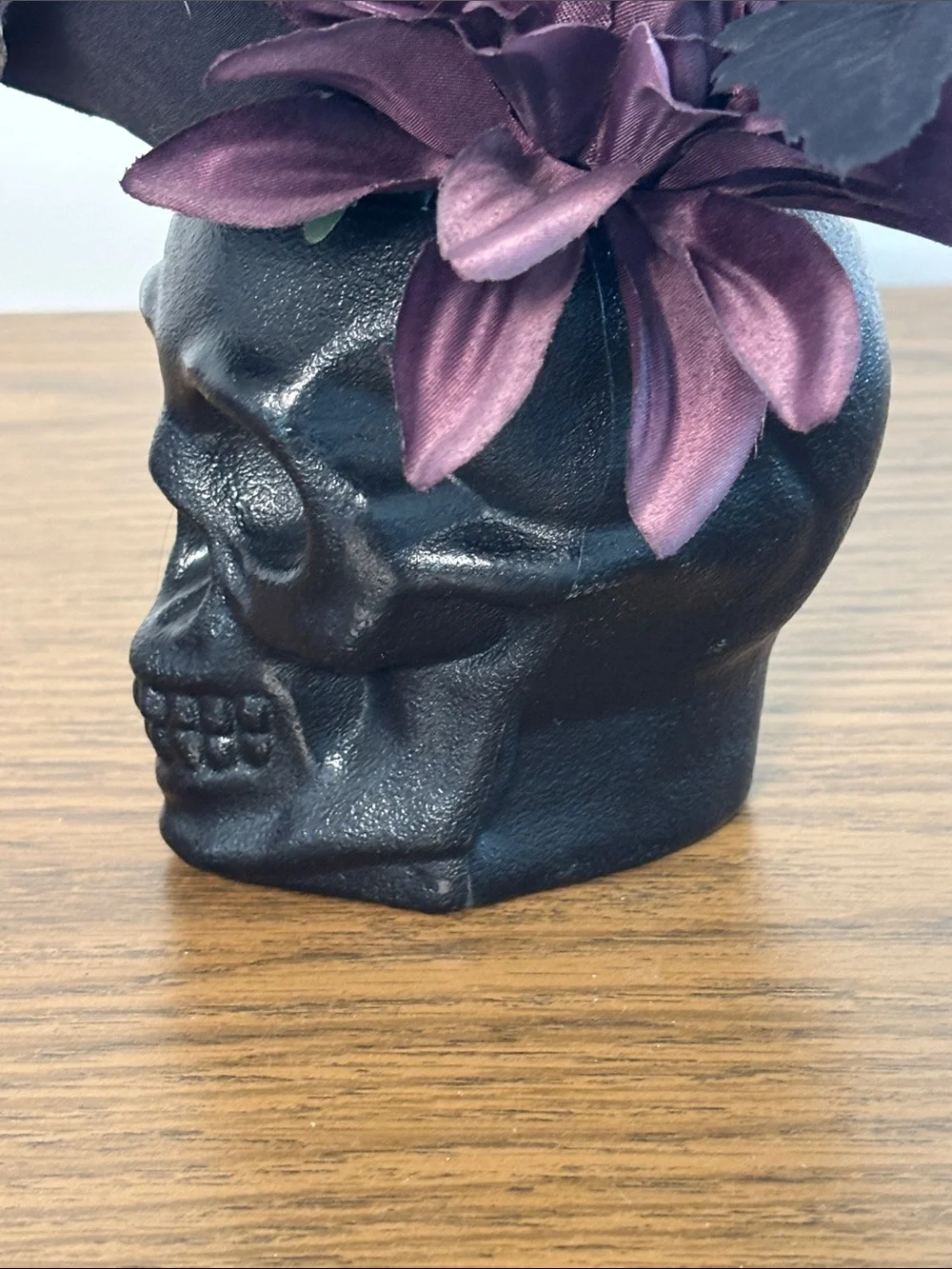 Black Skull Vase with Dark Purple Floral Arrangement